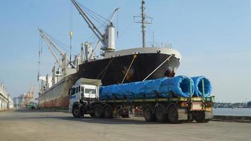 Container loading in a Cargo freight ship with industrial crane. Container ship in import and export business logistic company. Industry and Transportation concept. photo