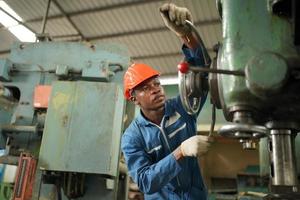 Maintenance Engineers is working in front of the automated CNC machinery repair on a maintenance checklist at the production line. photo