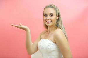 Portrait Of Smiling Young Woman with health skin care Over pink Background photo