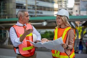 Architect of construction engineer working in construction site and management in the construction site photo