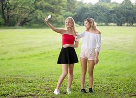 Close Up Portrait of beauty girl with fluttering white hair enjoying nature outdoors, on a field. Flying blonde hair on the wind. Breeze playing with girl's hair. Beautiful young woman face photo