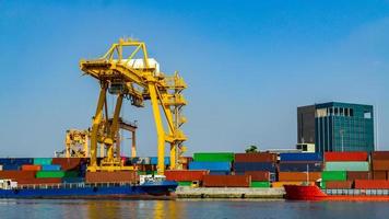 Container loading in a Cargo freight ship with industrial crane. Container ship in import and export business logistic company. Industry and Transportation concept. photo