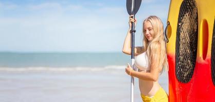 Portrait of a beautiful blonde woman enjoy her summertime on the beach. photo