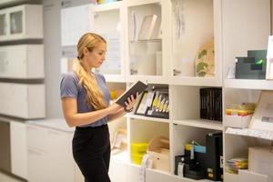 side view of women looking for something on bookshelf photo
