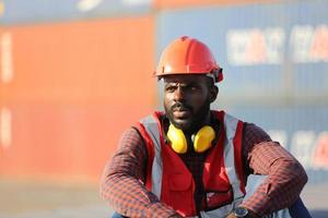 Engineer or supervisor checking and control loading Containers box from Cargo at harbor. Foreman control Industrial Container Cargo freight ship at industry. Transportation and logistic concept. photo