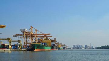 Container loading in a Cargo freight ship with industrial crane. Container ship in import and export business logistic company. Industry and Transportation concept. photo