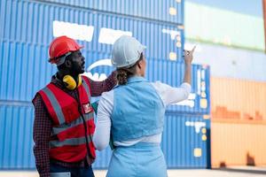 Foreman checking containers in the terminal, at import and export business logistic company. photo