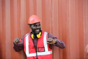 Engineer or supervisor checking and control loading Containers box from Cargo at harbor. Foreman control Industrial Container Cargo freight ship at industry. Transportation and logistic concept. photo