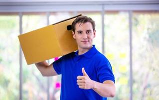 delivery man blue t-shirt holding box in call center office photo