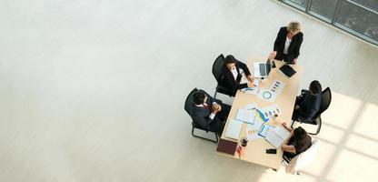 Top view on a group of businessman and businesswoman having a meeting and making a business commitment. photo