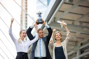 Successful business people standing together widen out showing strong relationship of worker community. A team of businessman and businesswoman expressing a strong group teamwork at the modern office. photo