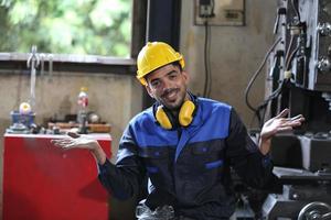 Professional industrial factory employee working with machine part, checking and testing industrial equipment and robot arms in large Electric electronics wire and cable manufacturing plant factory photo