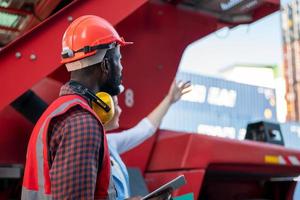 Foreman checking containers in the terminal, at import and export business logistic company. photo