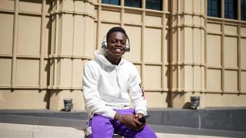 Afro American man having fun walking in city center - Happy young guy enjoying time a sunset outdoor - Millennial generation lifestyle and positive people attitude concept photo