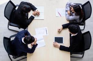 Top view on a group of businessman and businesswoman having a meeting and making a business commitment. photo