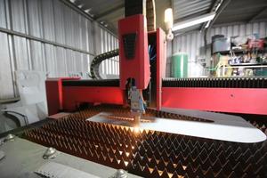 Automatic plasma laser cutting machine working in metalwork factory.. photo