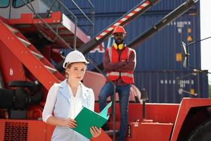 foreman checking containers in the terminal, at import and export business logistic company. photo