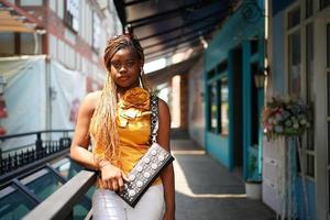 Portrait of young Black skin girls with Afro hairstyle outdoor posing. photo