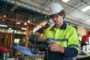 Foreman or worker work at factory site check up machine or products in site. Engineer or Technician checking Material or Machine on Plant. Industrial and Factory. photo