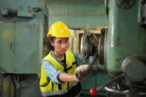 Female Maintenance Engineers is working in front of the automated CNC machinery repair on a maintenance checklist at the production line. photo