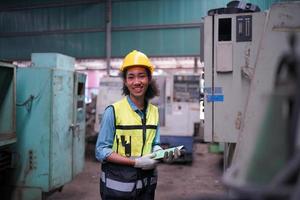 Female worker Foreman or worker work at factory site check up machine or products in site. Engineer or Technician checking Material or Machine on Plant. Industrial and Factory. photo