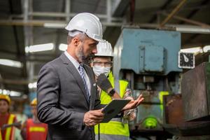 Worker work at factory site check up machine in products line or products in site. Engineer or Technician checking Material or Machine on Plant. Industrial and Factory. photo