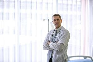 Doctor With Arms Crossed Holding Stethoscope photo