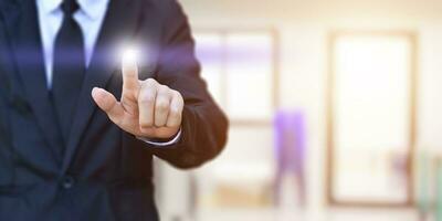 Businessman finger pressing an imaginary screen. Idea for business, technology, internet and networking. photo