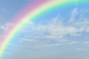 Rainbow on blue sky with white cloud background. photo