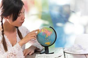 Women explore the globe to plan their trip photo