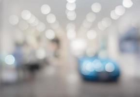 defocused image of car stand in show room photo