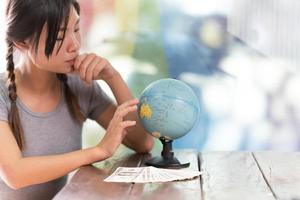 Women explore the globe to plan their trip photo