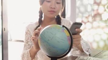 Women explore the globe to plan their trip photo