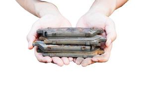 Hand holding an old brake pad on a white background photo