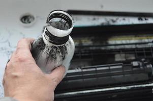 Charging the laser printer cartridge with toner powder photo