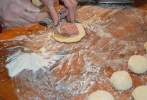 Cooking homemade whites with meat on yeast dough photo