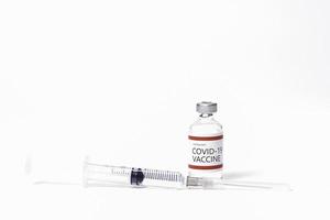 Coronavirus vaccine, syringe and needle on white background. photo