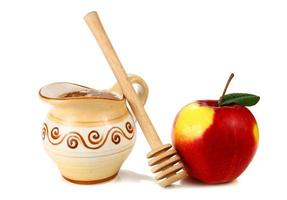 miel en una jarra y manzana foto