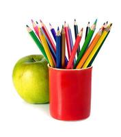 coloured pencils and green apple photo