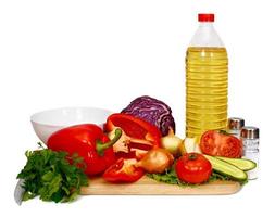 sunflower seed oil and vegetables for preparation of salad photo