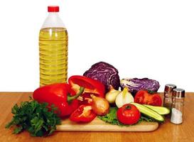 sunflower seed oil and vegetables for preparation of salad photo