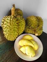Durian, monthong riped and fresh, peel with yellow colour on wooden table. photo