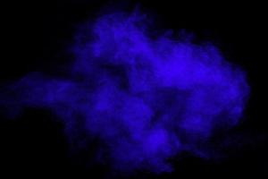 Blue color dust particles splash on black background. photo