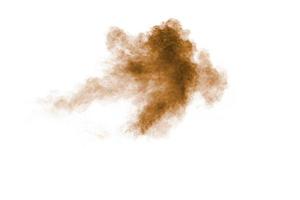 Brown dust explosion cloud.Brown particles splatter on white background. photo