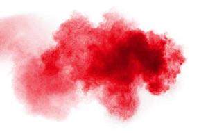 Red powder explosion on white background. Freeze motion of red dust particles splash. photo