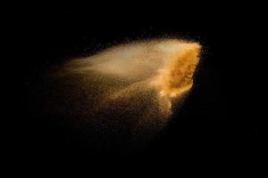 Dry river sand explosion isolated on black background. Abstract sand cloud.Brown colored sand splash against dark background. photo