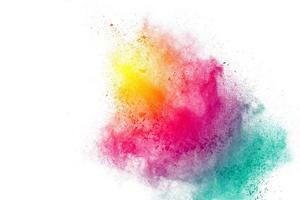 Painted powder explosion on white background. Yellow-Red-Green dust explode for celebration or holiday design element. photo