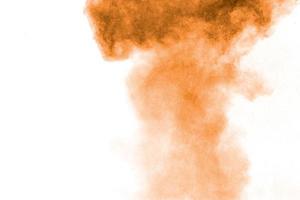 Freeze motion of brown dust explosion. Stopping the movement of brown powder. Explosive brown powder on white background. photo