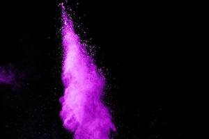 Pink Color powder splash cloud isolated on black background photo