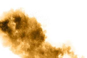 Freeze motion of brown dust explosion. Stopping the movement of brown powder. Explosive brown powder on white background. photo